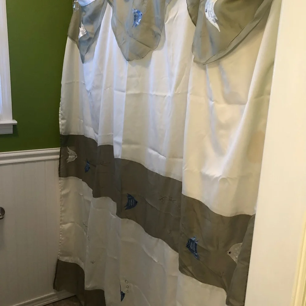 Green and cream fabric shower curtain with embroidered fish
